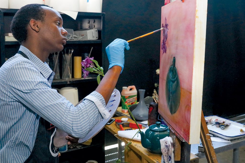 Art student working on an oil painting