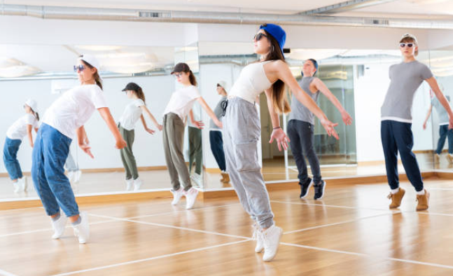 students learning hip-hop dance in studio