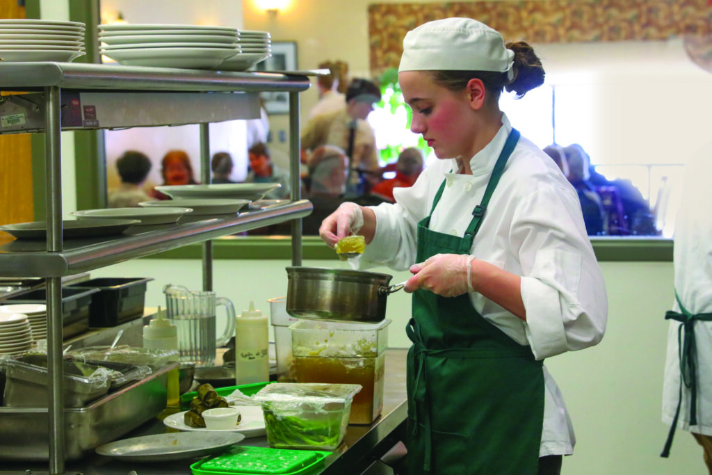 Student preparing food at the Hilltopper restaurant