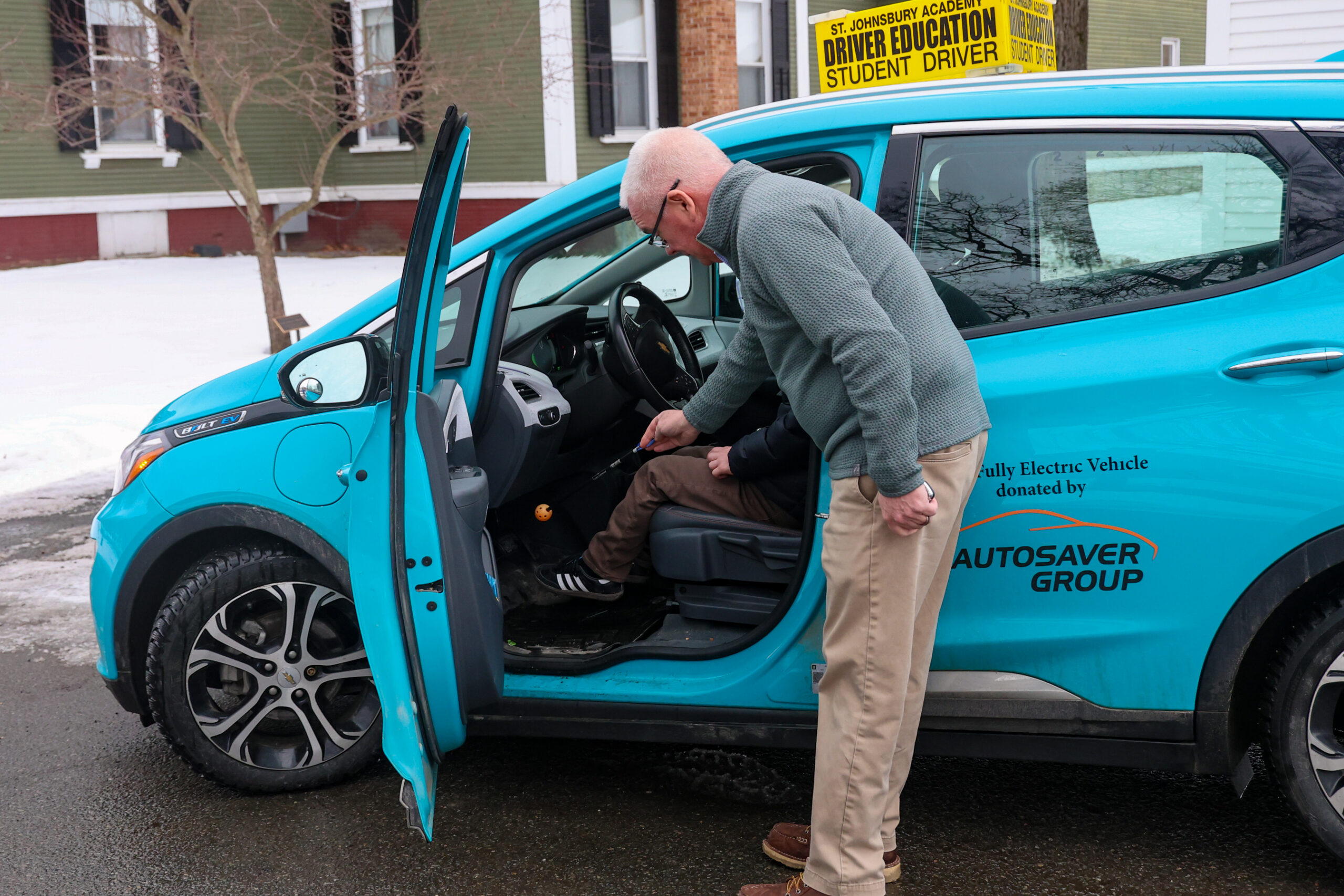 Student receiving instruction from driver's ed teacher