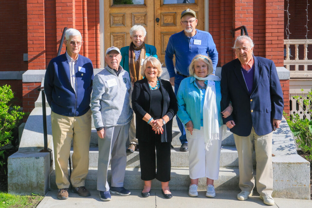 An alumni group poses for a group photo
