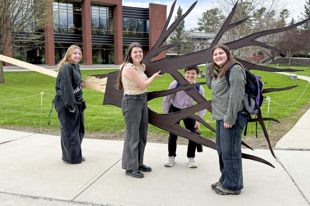 students walking with a theater prop.