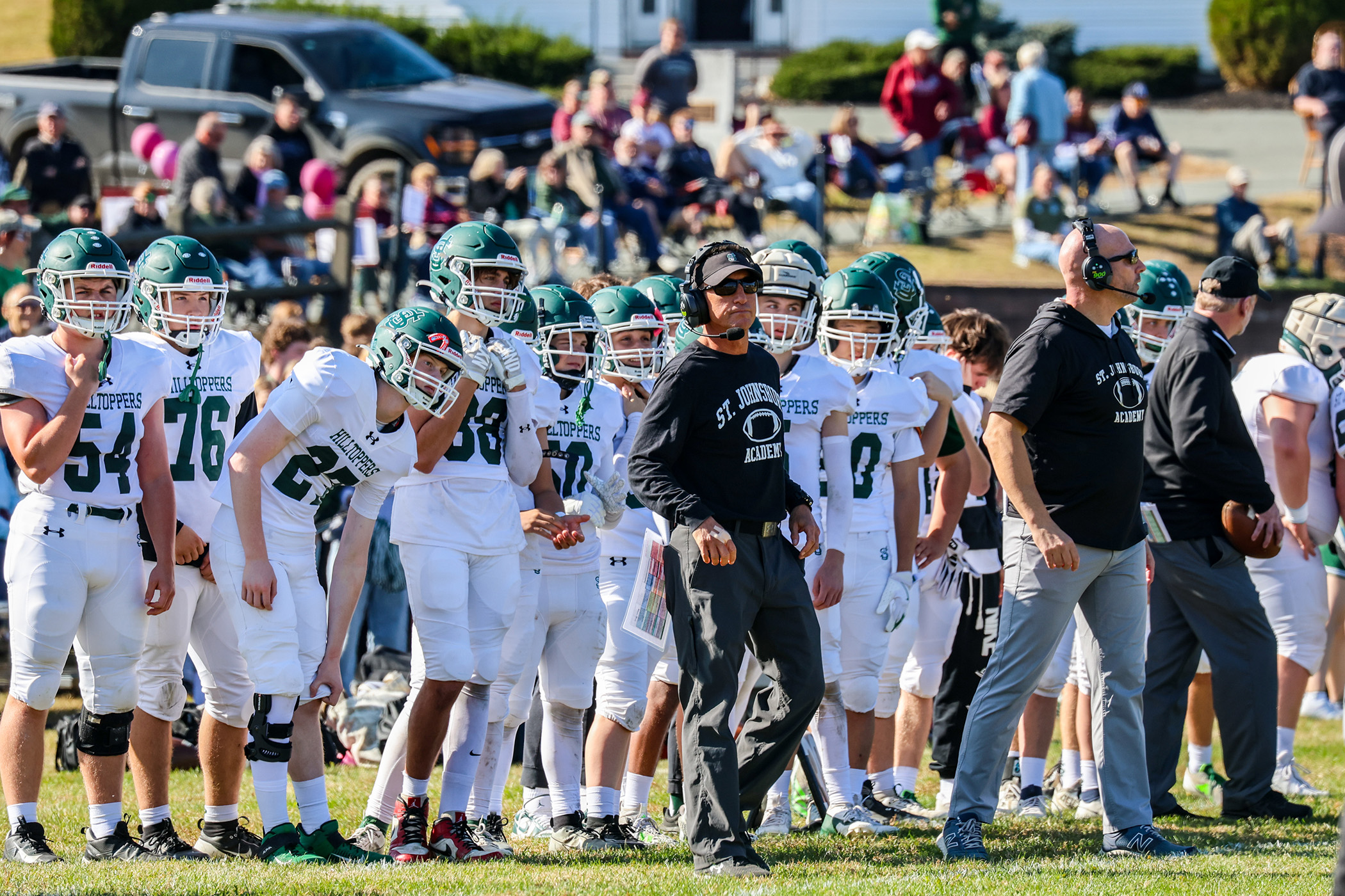 football coach on the sideline with players
