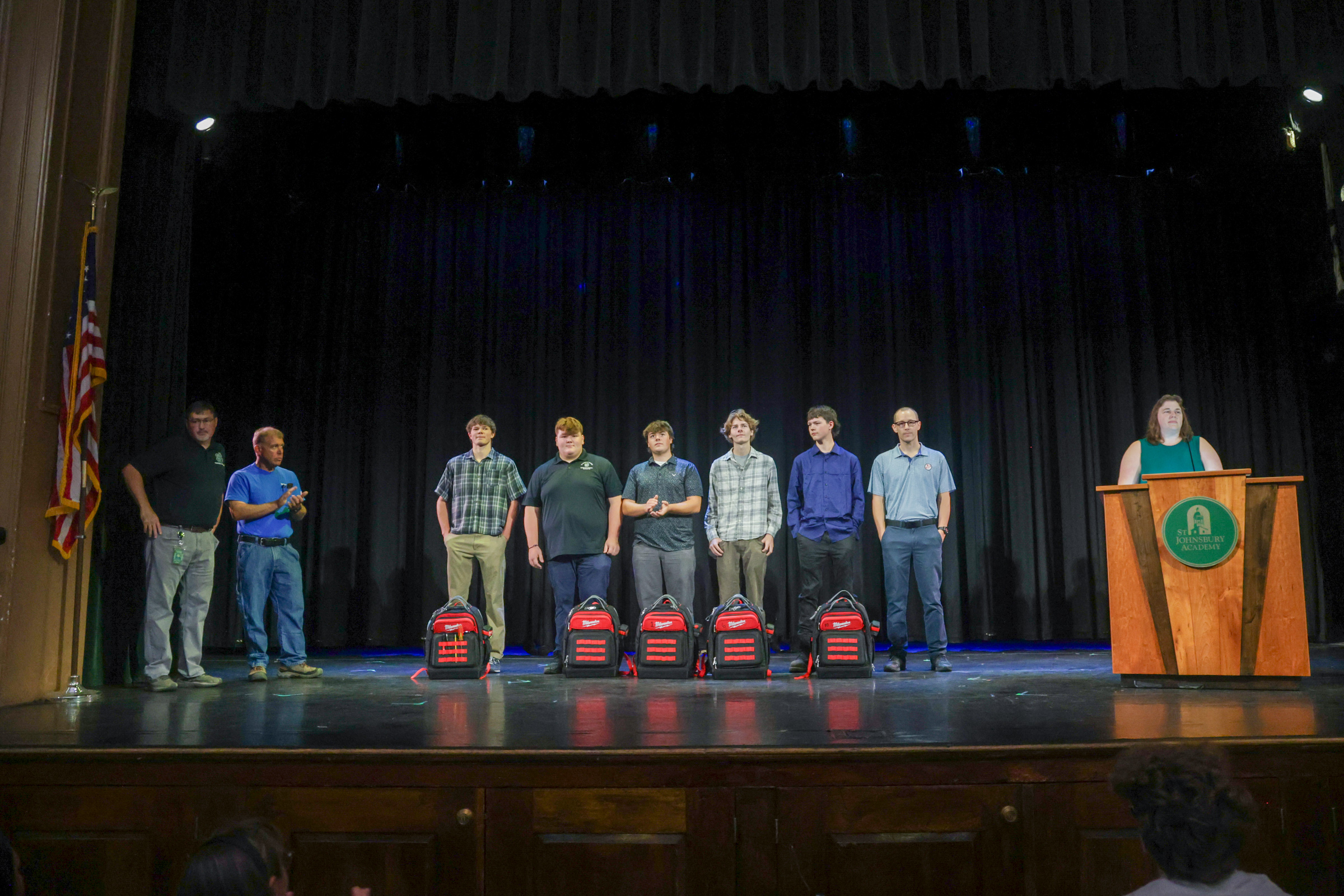 Students gather on the stage in Fuller Hall.