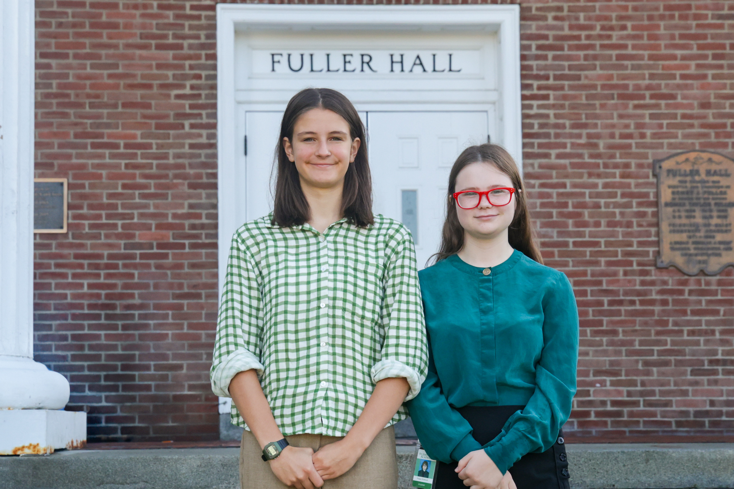 girls stand on Fuller Hall steps.